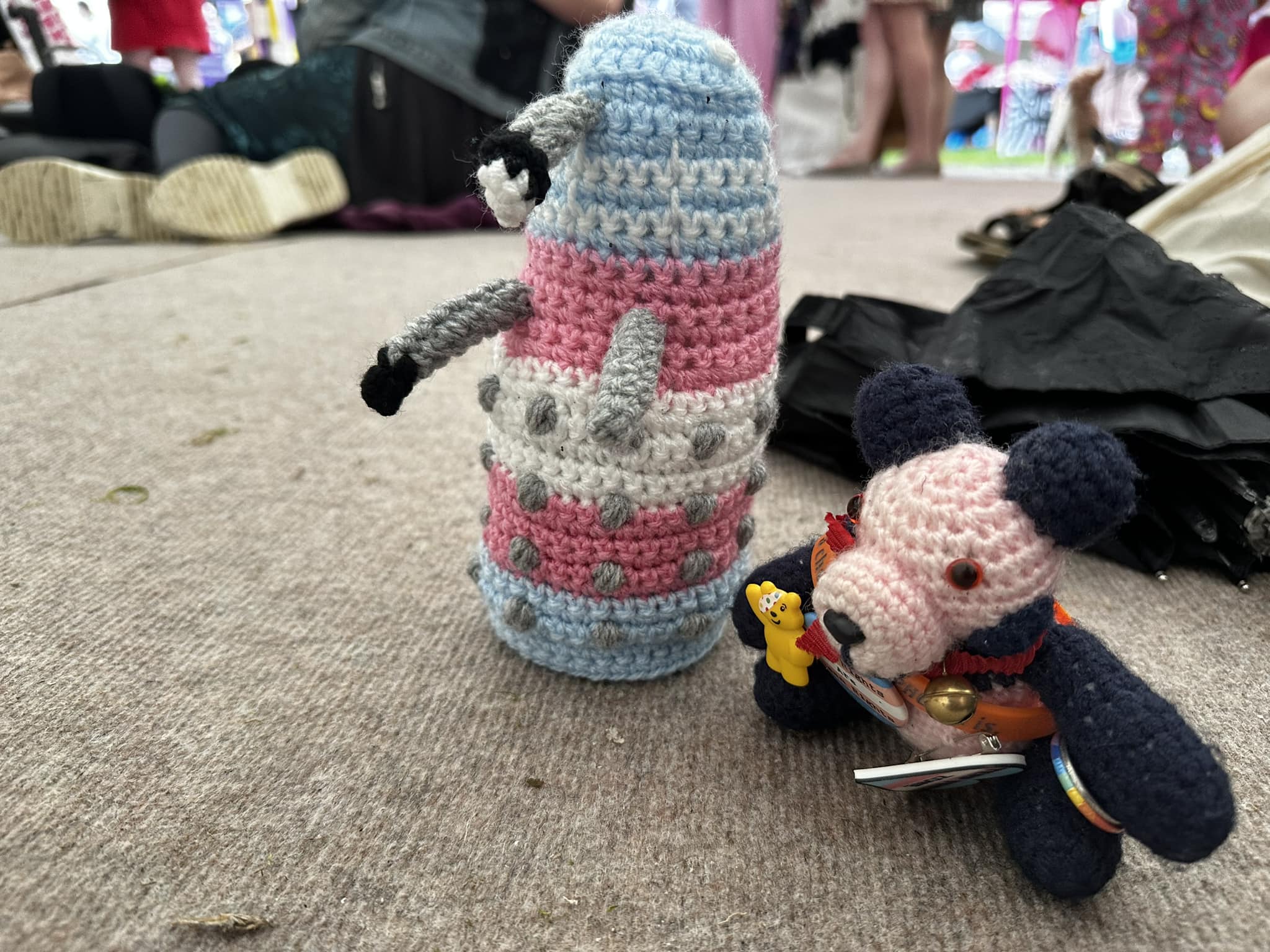 Crocheted panda and Dalek in a tent