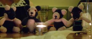 Diamonds panda mascots sitting around a candle